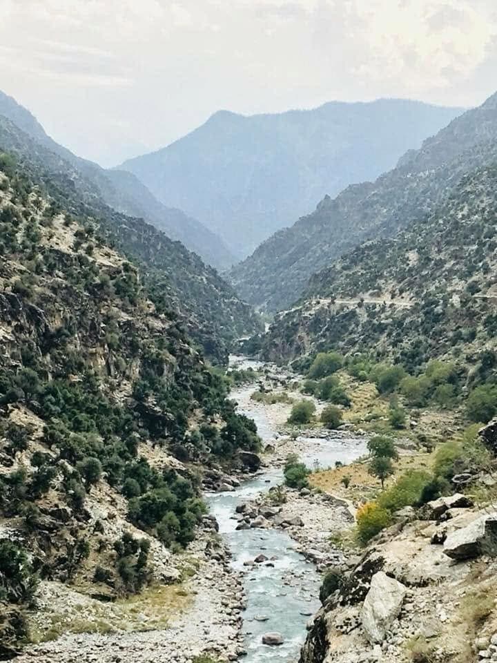 A turquoise river winding through a rocky gorge