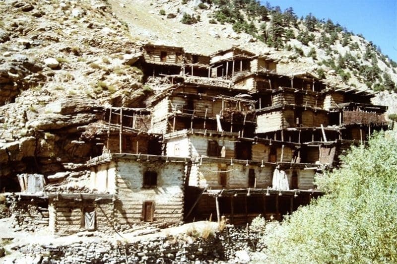 Traditional stacked-timber Nuristani village built into a mountainside