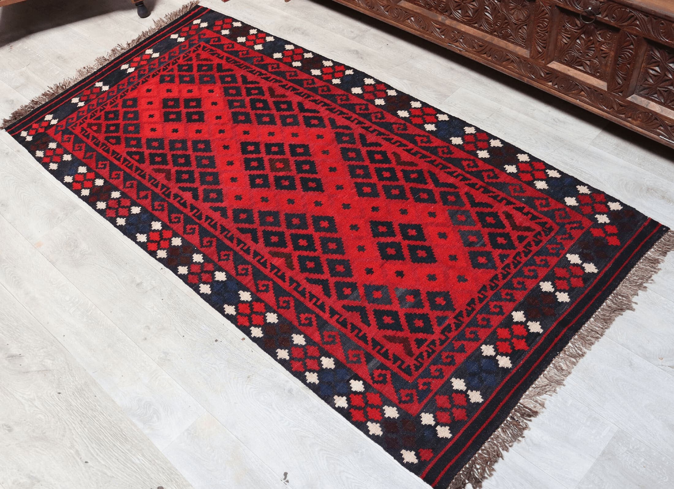 A detail of a hand-woven Nuristani wool rug